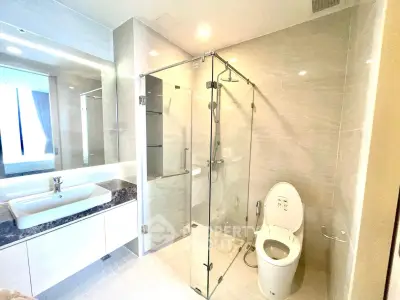 Luxurious modern bathroom with glass shower and sleek fixtures
