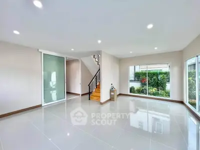 Spacious modern living room with large windows and garden view