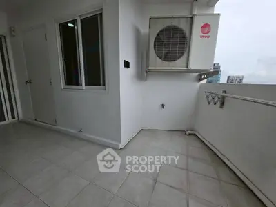 Modern balcony with air conditioning unit and city view, perfect for urban living.