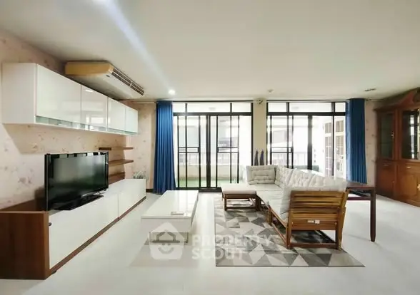 Spacious living room with modern furniture and large windows for natural light.