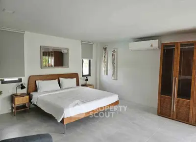 Spacious modern bedroom with minimalist design and natural light