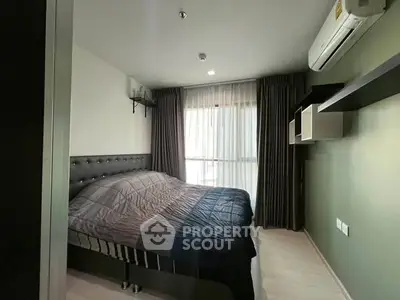 Modern bedroom with stylish decor and natural light in a contemporary apartment.