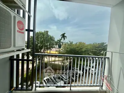 Charming balcony with lush garden view and ample space for relaxation.