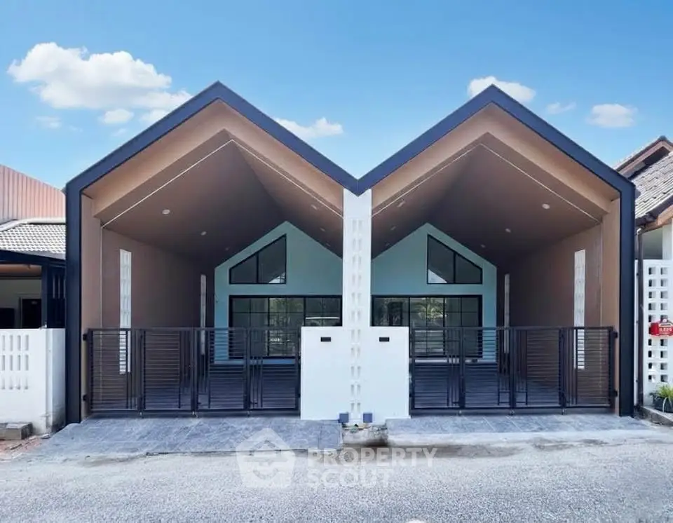 Modern duplex house with unique roof design and spacious driveway