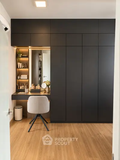 Modern study room with sleek black cabinetry and stylish chair, perfect for productivity and organization.
