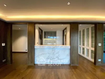 Luxurious modern kitchen with marble island and elegant wood flooring