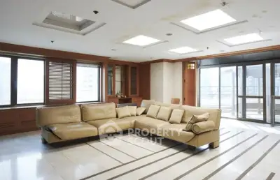 Spacious living room with large windows and modern sectional sofa