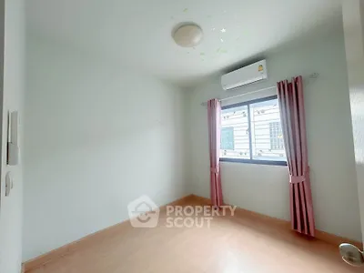 Bright empty bedroom with air conditioning and pink curtains, ready for personalization.