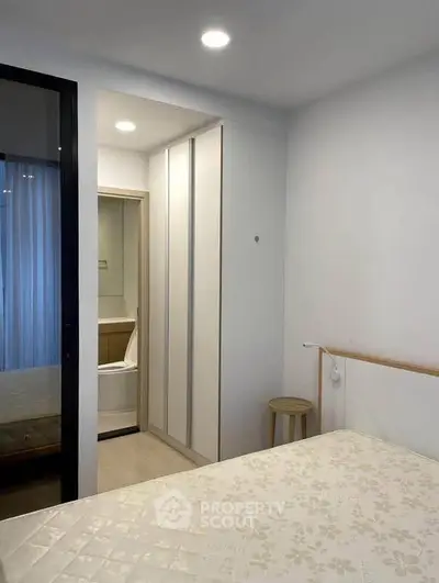 Modern bedroom with ensuite bathroom and sleek wardrobe design