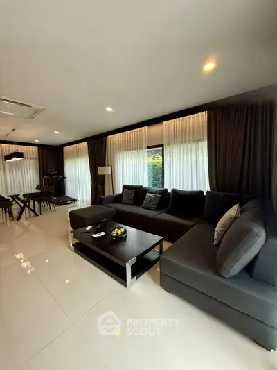 Spacious modern living room with elegant decor and large windows