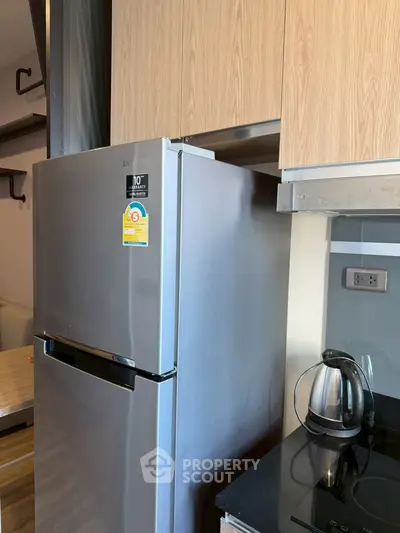 Modern kitchen with stainless steel fridge and sleek countertop