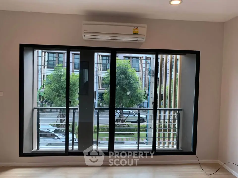 Modern living room with large windows and balcony view