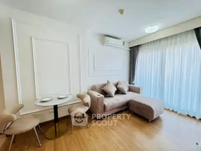 Modern living room with stylish furniture and large window for natural light.