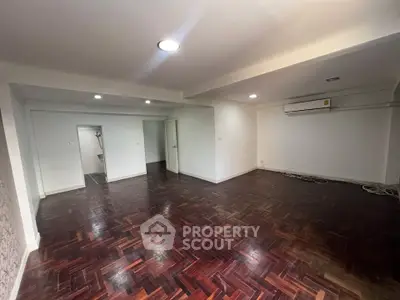 Spacious living room with wooden flooring and modern lighting