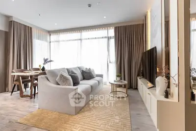 Modern living room with elegant decor and large windows in a stylish apartment.