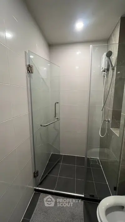 Modern bathroom with glass shower enclosure and sleek tile design