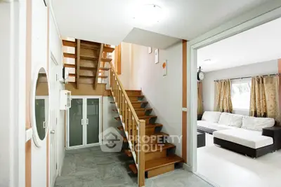 Modern interior with wooden staircase and cozy living room