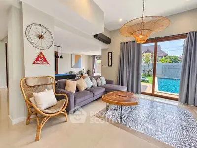 Spacious living room with pool view, stylish decor, and natural light.