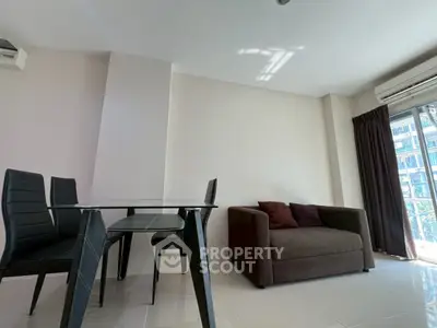 Modern living room with sleek furniture and large window for natural light.