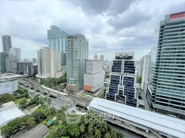 Stunning cityscape view from high-rise building in urban area with skyscrapers and lush greenery.