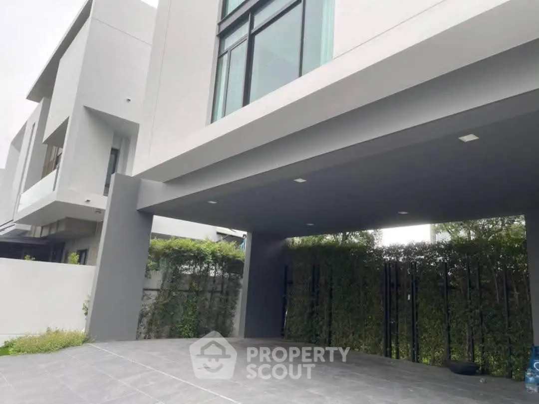 Modern architectural exterior with sleek design and spacious driveway in a contemporary residential building.