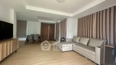 Spacious modern living room with sleek furniture and elegant curtains