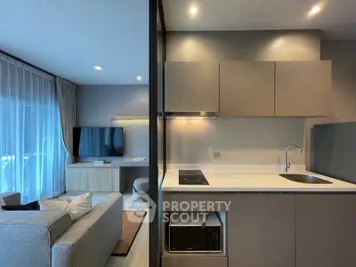 Modern open-plan living room and kitchen with sleek design and natural light