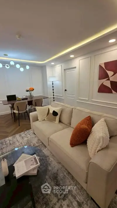 Elegant living room with modern decor, cozy sofa, and stylish dining area, perfect for contemporary living.