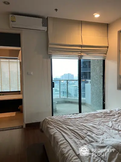 Modern bedroom with balcony view in high-rise apartment