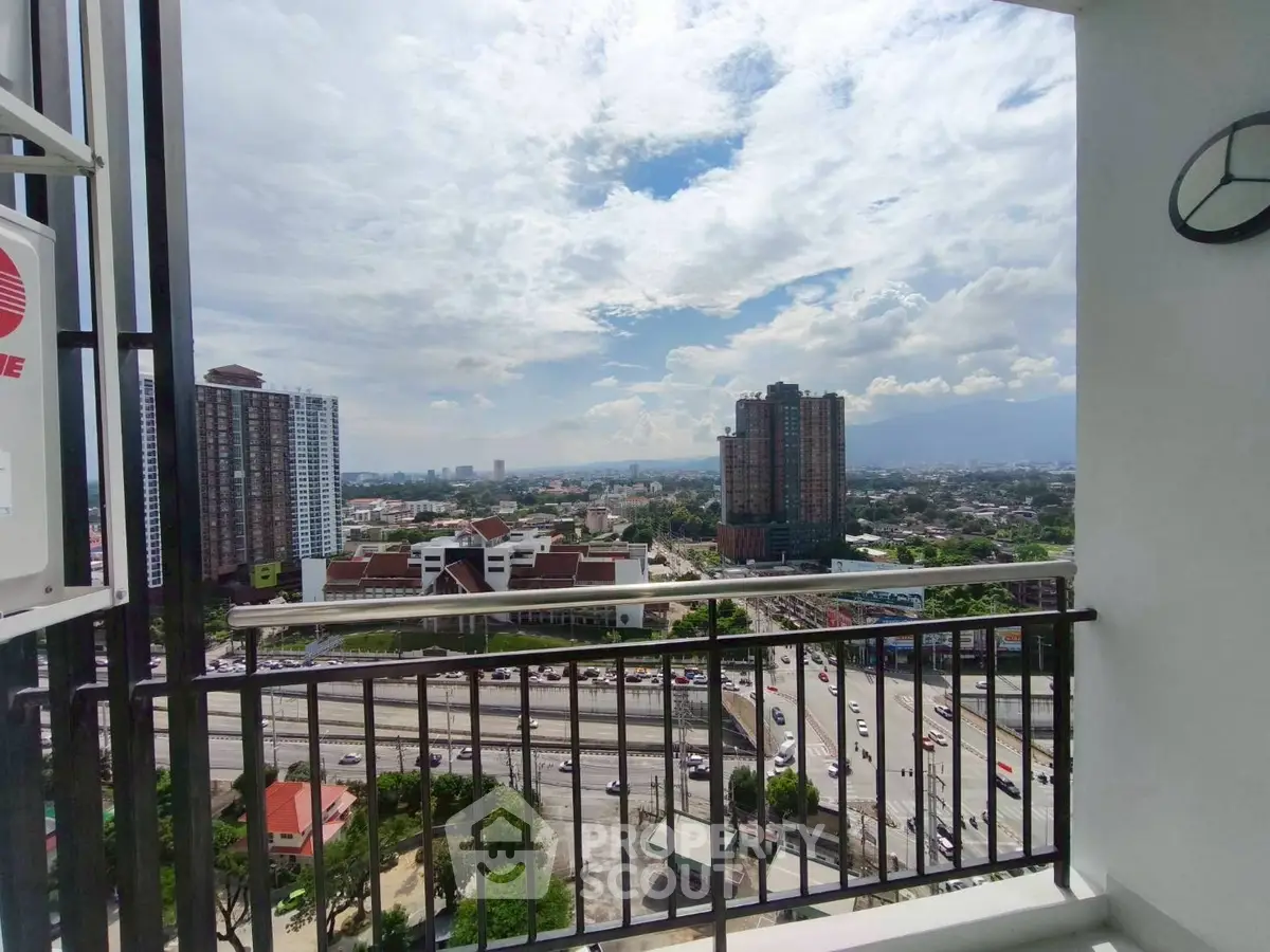 Stunning high-rise balcony view with cityscape and clear skies