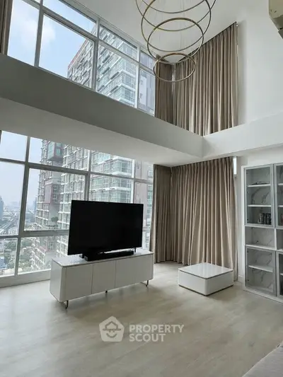 Luxurious high-ceiling living room with floor-to-ceiling windows and modern decor in a city apartment.