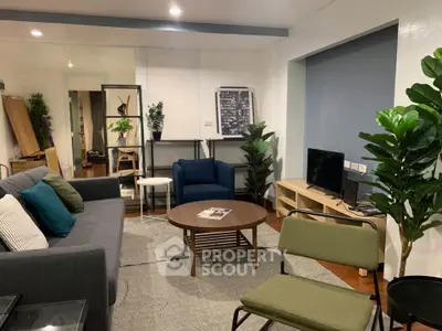 Modern living room with stylish furniture and indoor plants, perfect for cozy gatherings.