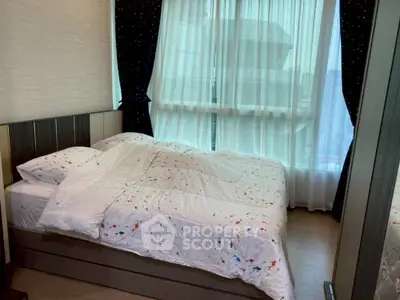 Cozy bedroom with large window and elegant curtains in modern apartment.