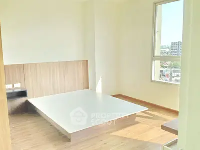 Bright minimalist bedroom with large window and wooden flooring