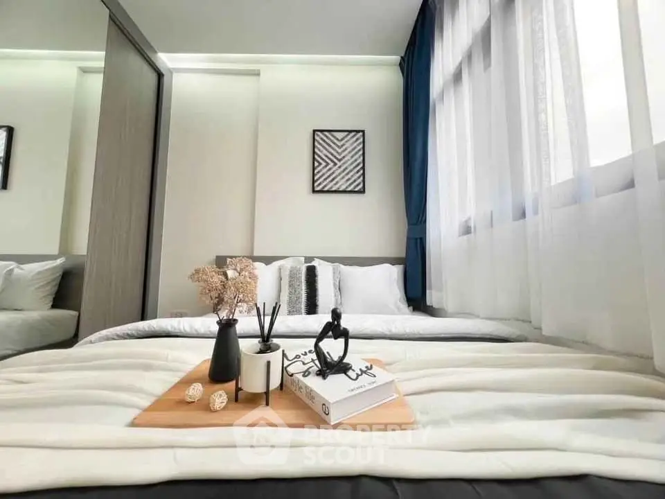 Modern bedroom with stylish decor and large window for natural light