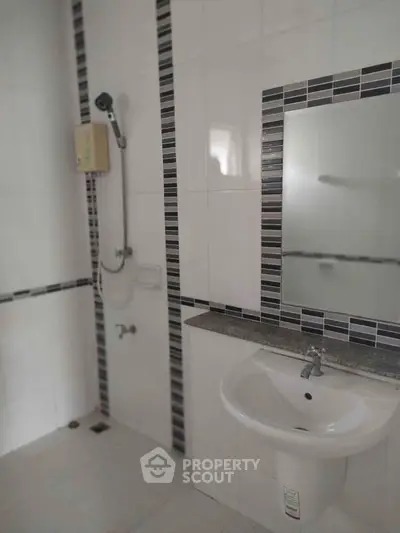 Modern bathroom with sleek tiles and stylish fixtures in a contemporary home.