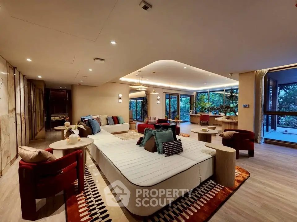 Luxurious open-plan living room with modern decor and large windows offering stunning views.