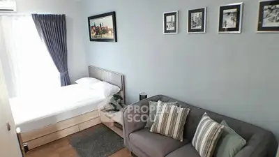 Cozy bedroom with stylish decor and comfortable seating area in modern apartment.