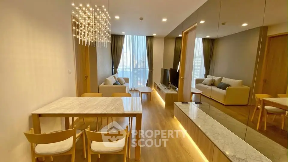 Modern living room with elegant chandelier and spacious seating area