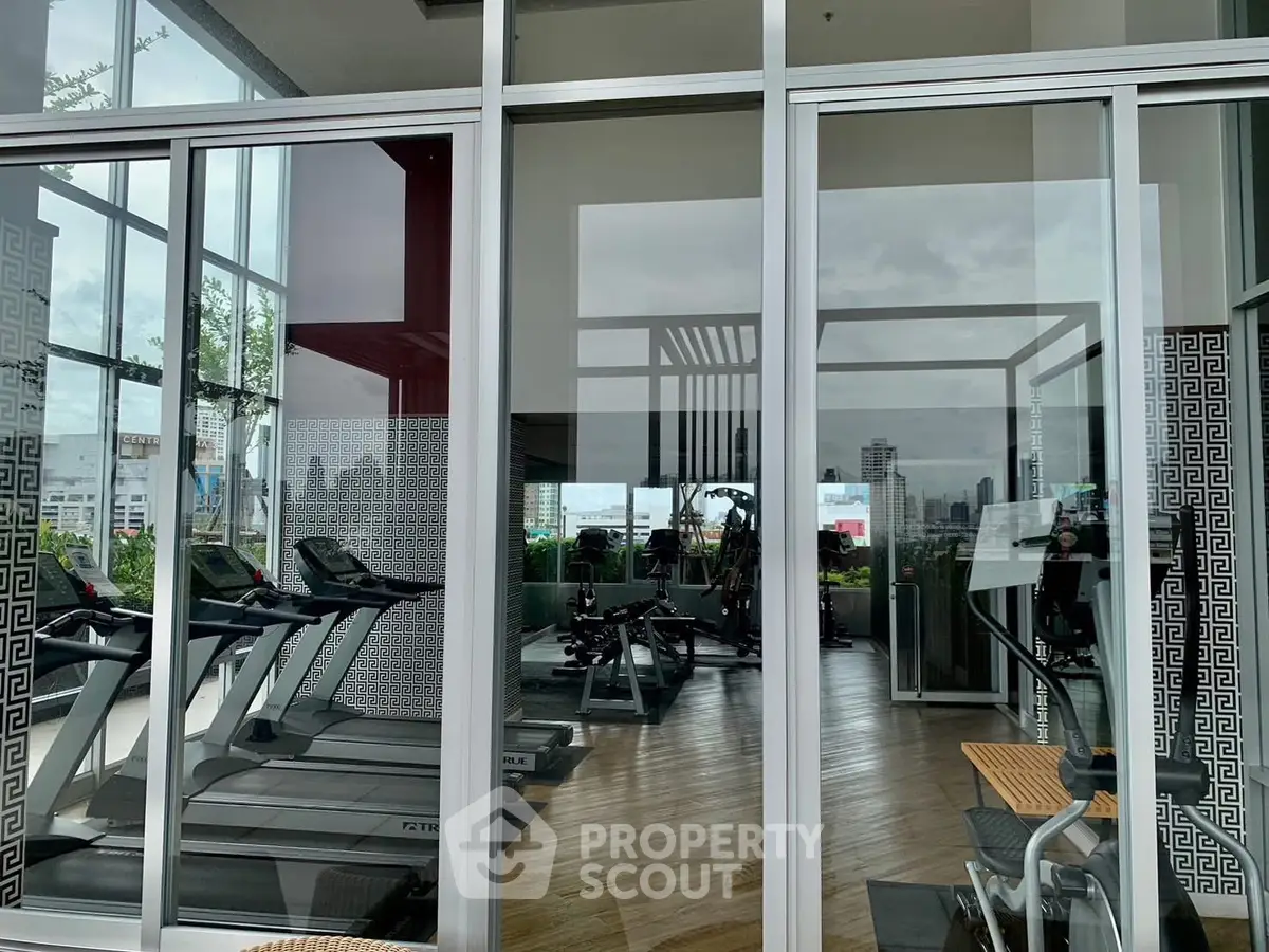 Modern gym with city view in luxury residential building