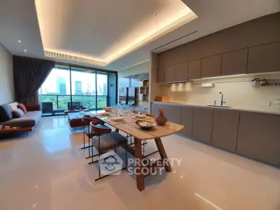 Luxurious open-plan living room with modern kitchen and stunning city view balcony.