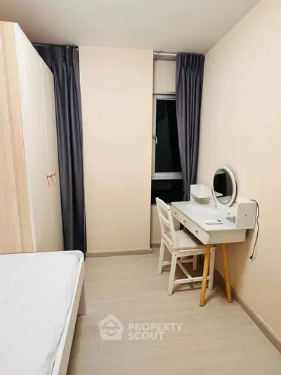 Cozy bedroom with minimalist decor and study area, perfect for relaxation and productivity.