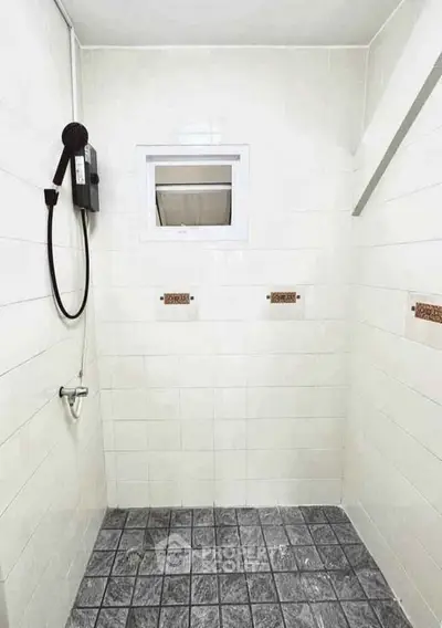 Spacious minimalist bathroom with modern shower and tiled walls, perfect for a sleek and functional home design.