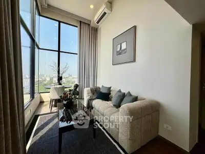 Luxurious living room with panoramic city view, elegant decor, and plush seating in a high-rise apartment.