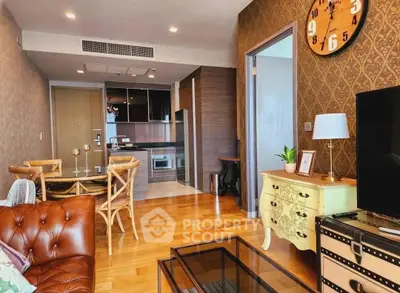 Chic living room with vintage decor and modern kitchen in open layout apartment.