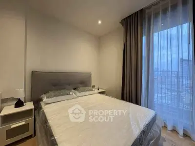 Modern bedroom with large window and city view, featuring a comfortable bed and stylish decor.