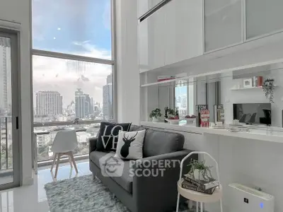 Modern living room with city view, stylish decor, and large windows in a high-rise apartment.