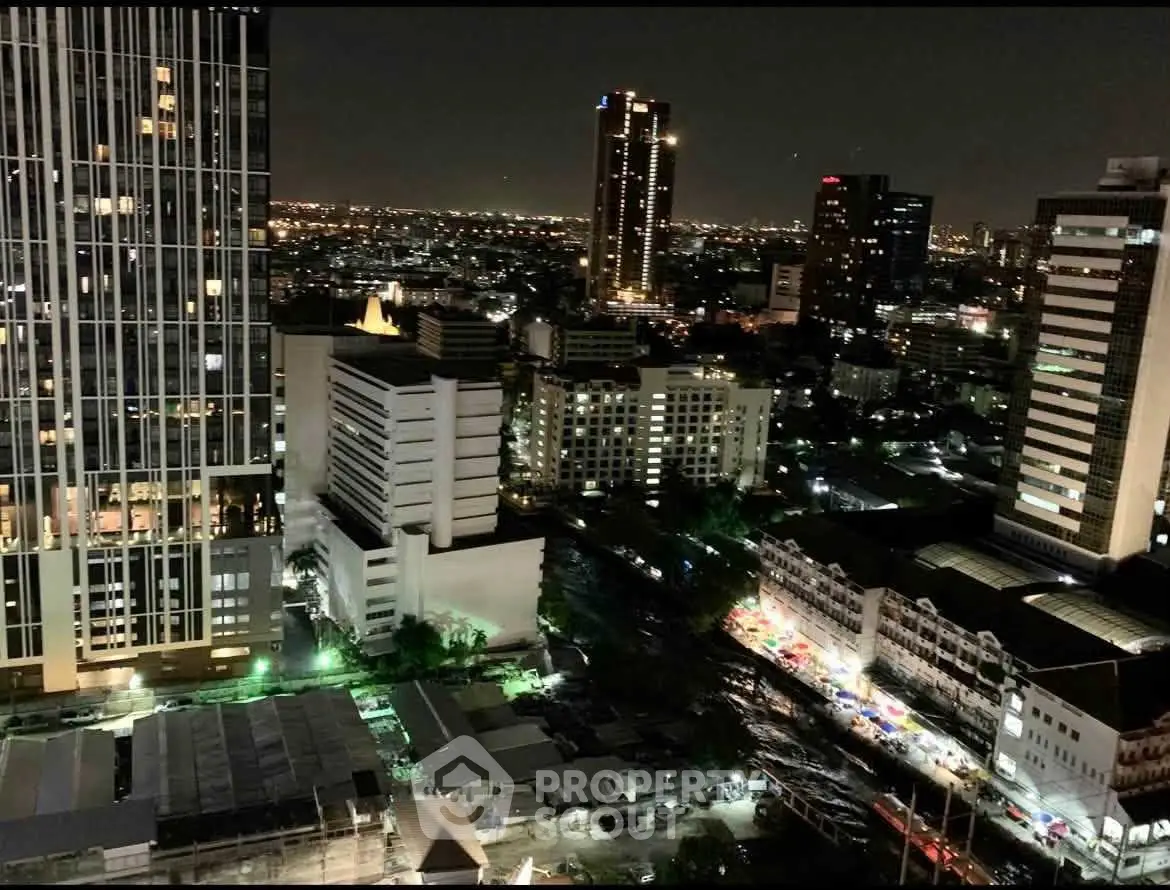Stunning night cityscape view from high-rise building showcasing vibrant urban skyline.