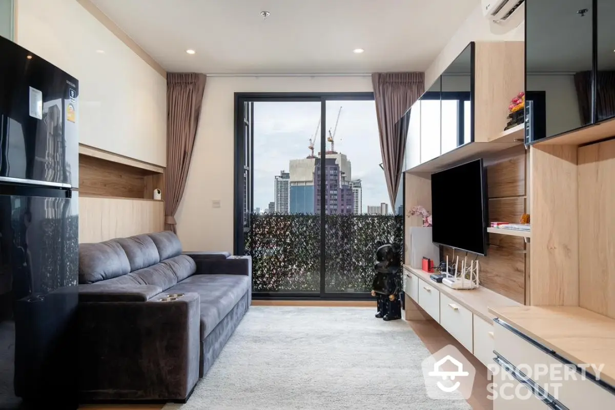 Modern living room with city view, sleek furniture, and large window for natural light.