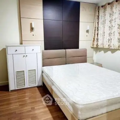 Spacious bedroom with modern design and hardwood flooring